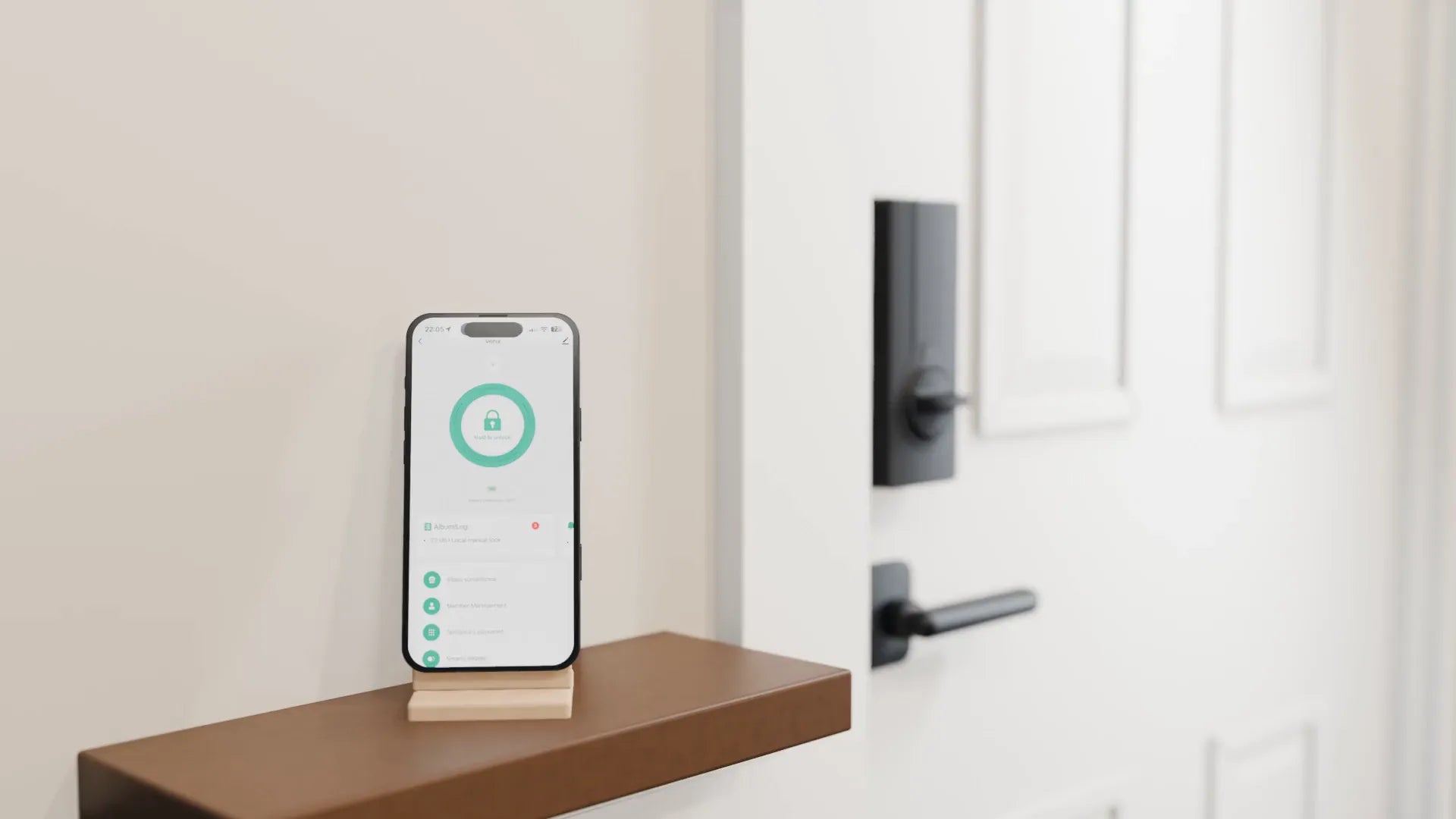 A phone on a hall shelf shows the Tuya Smart app beside Venix on the inside of the door